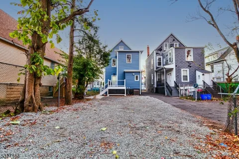 a view of a house with a yard and sitting area