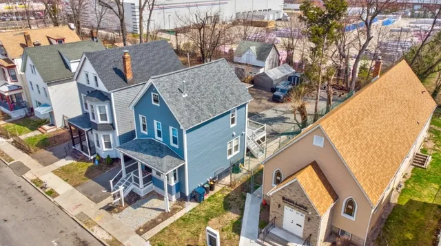 a aerial view of a house with large trees