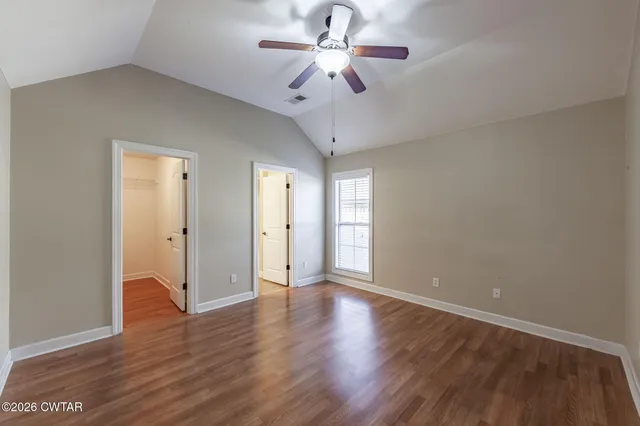 a view of an empty room and wooden floor