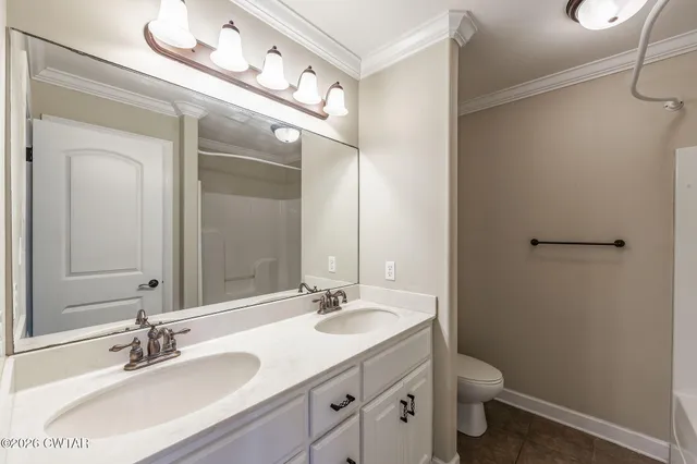a bathroom with a granite countertop sink a toilet and shower