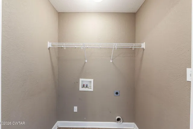 a view of a livingroom with an empty space and a window