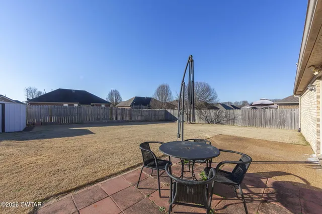 a view of a backyard of the house