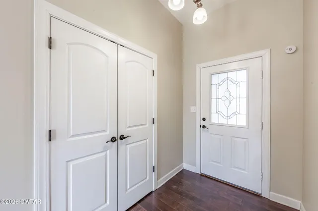 a view of empty room with wooden floor and fireplace