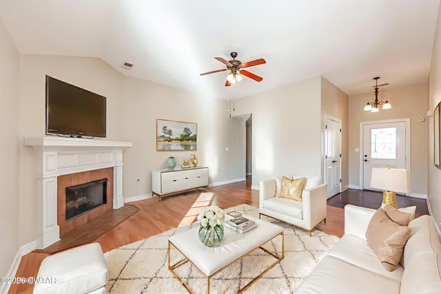 an empty room with windows and fireplace