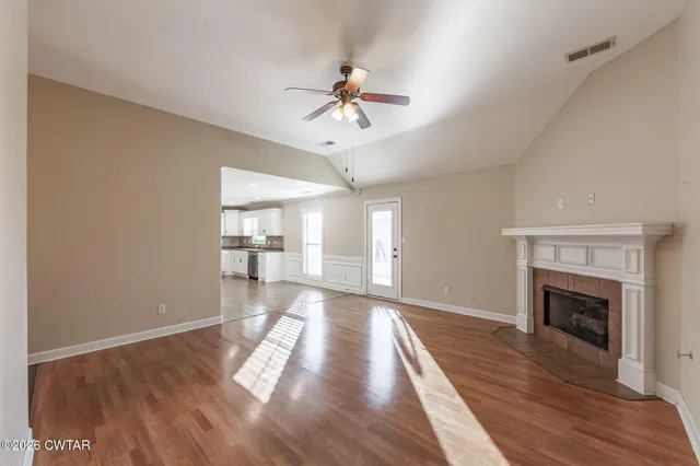 a kitchen with white cabinets and window