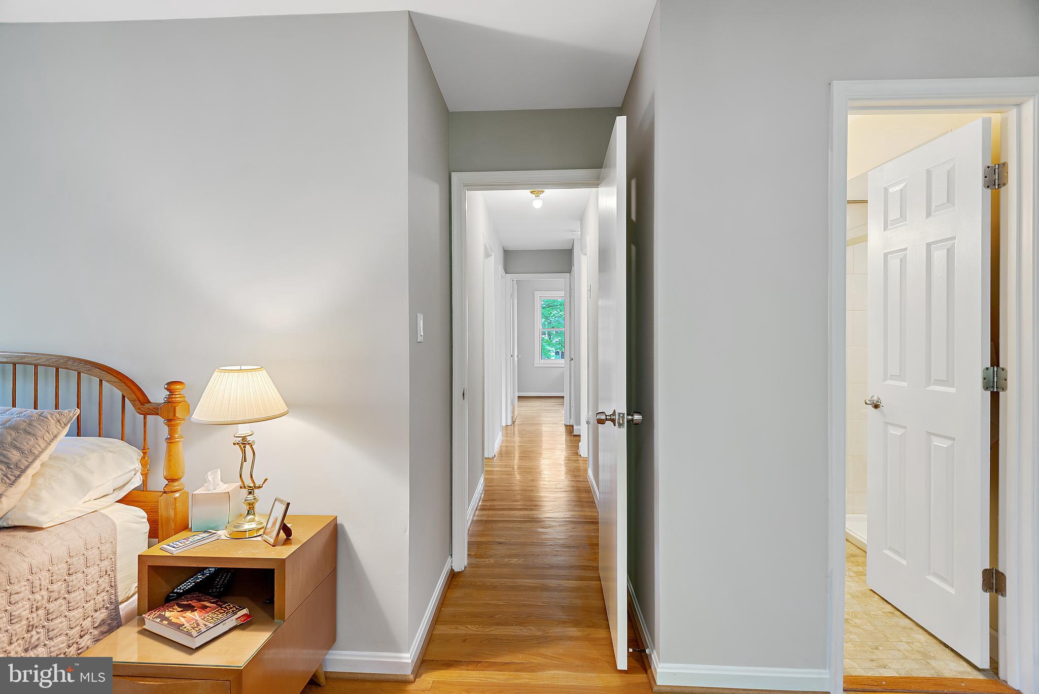 223 Summit Hall Road Gaithersburg, MD 20877 - Photo 42 of 60 a view of a hallway with couches and dining table with wooden floor
