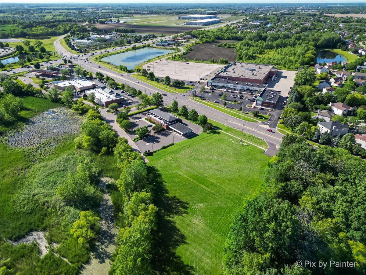 6850 Huntley Road Carpentersville, IL 60110 - Photo 12 of 16 an aerial view of residential houses with outdoor space and parking