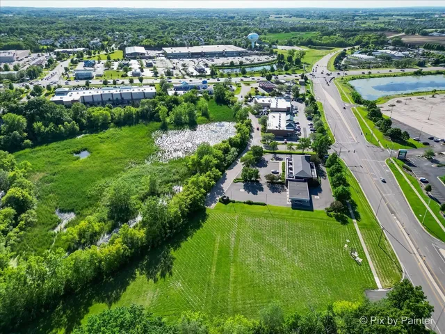 an aerial view of residential houses with outdoor space and river
