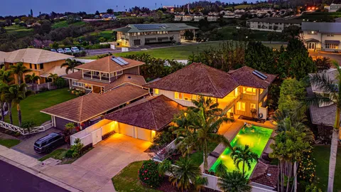 an aerial view of a house with a garden and swimming pool