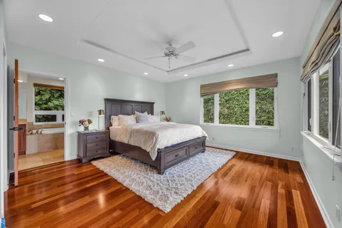 a bedroom with a large bed and a chandelier