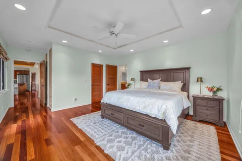 a spacious bathroom with a tub sink and mirror