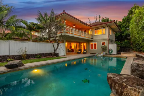 a house view with swimming pool and sitting space