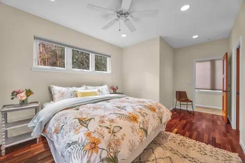 a bathroom with a sink a toilet a mirror and shower