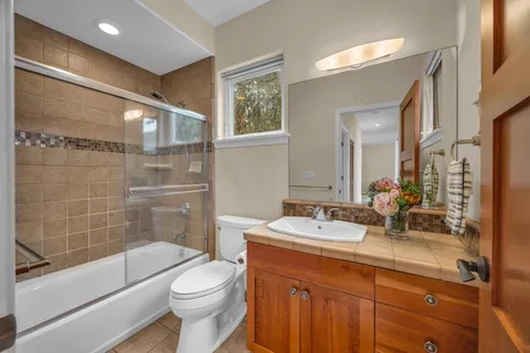 a bedroom with furniture and a ceiling fan