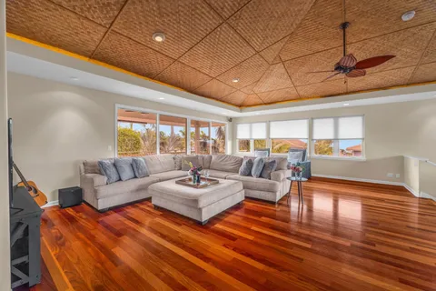 a living room with furniture and wooden floor