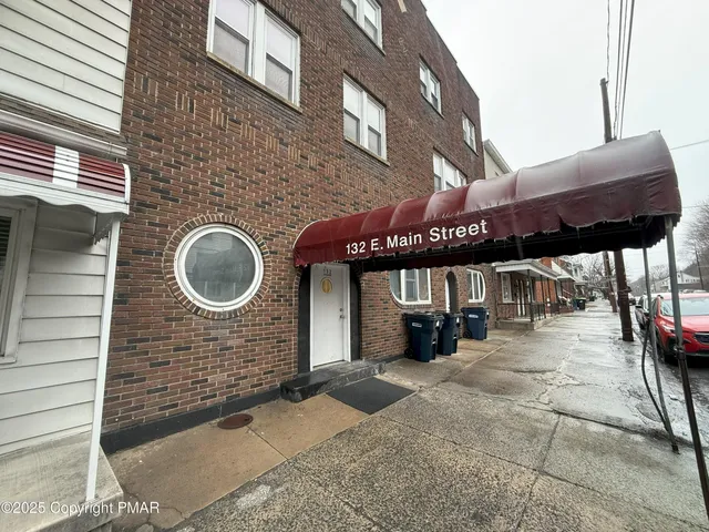a view of a brick building with a canopy over it