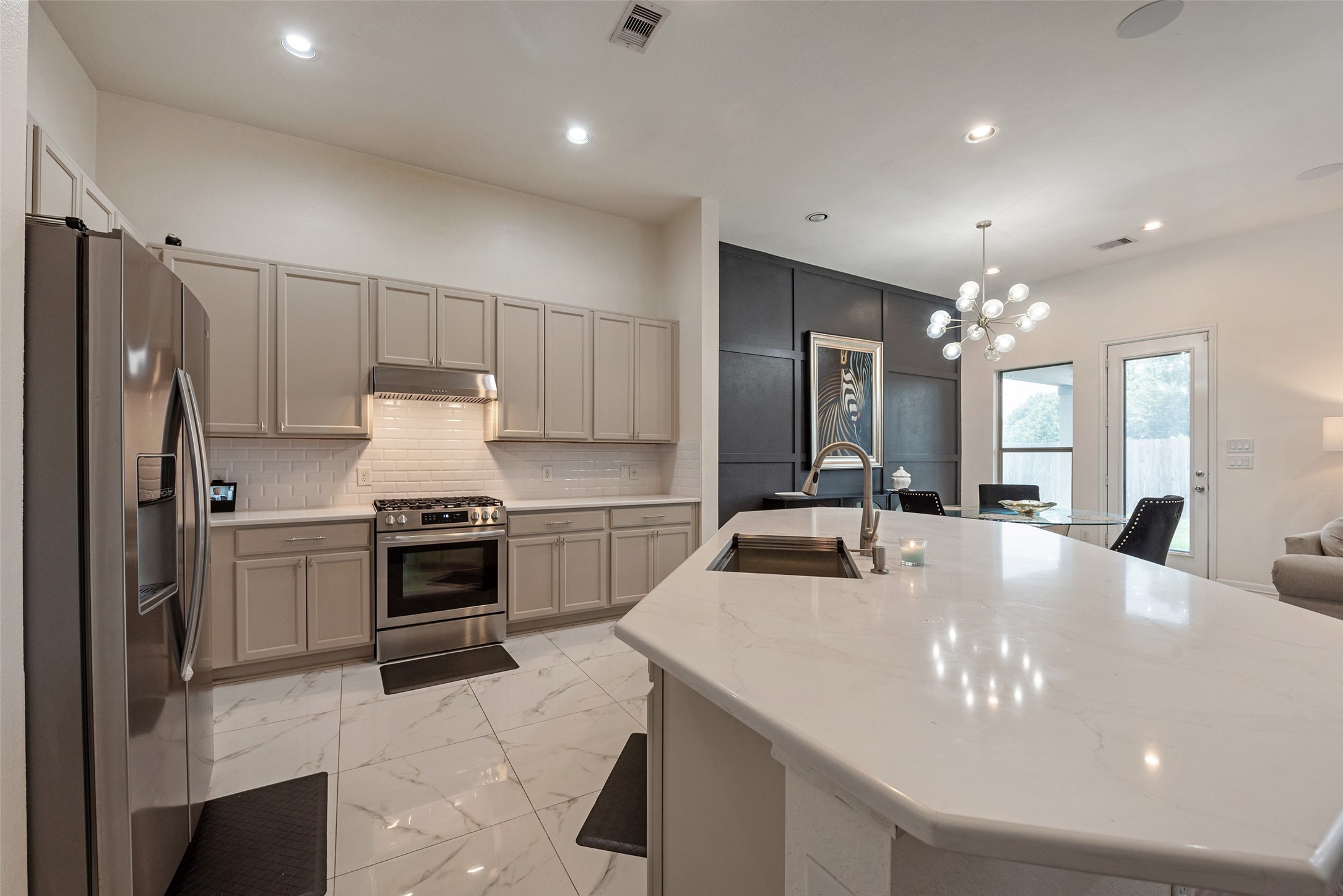 3554 Bennett Trails Drive Spring, TX 77386 - Photo 9 of 44 a kitchen with kitchen island a sink stainless steel appliances and cabinets