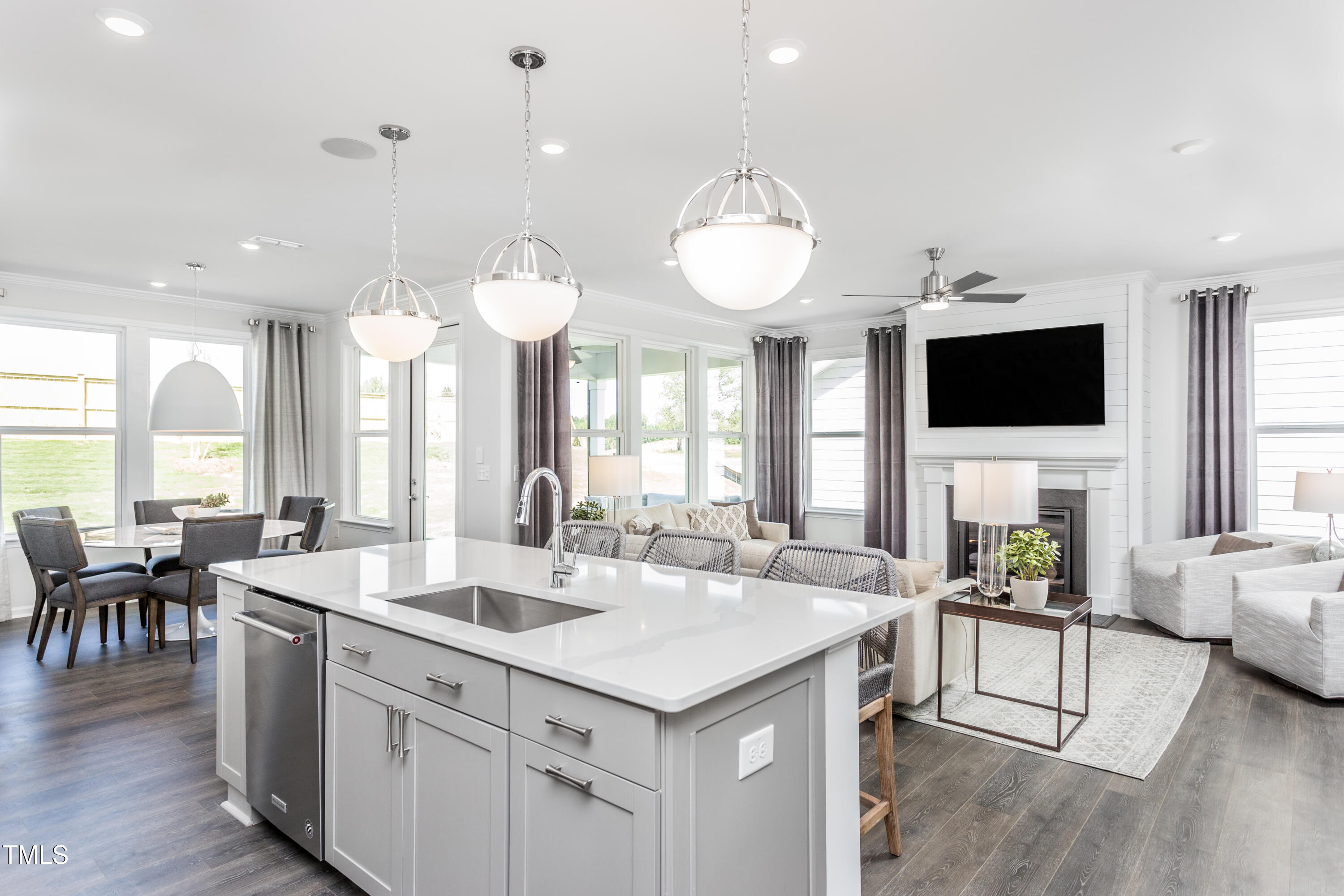 304 Arcadius Drive Clayton, NC 27520 - Photo 4 of 21 a large living room with stainless steel appliances kitchen island a large island in the center