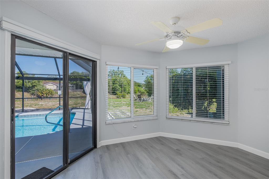 8285 Galgano Lane Spring Hill, FL 34606 - Photo 15 of 55 a view of an empty room with wooden floor and a window