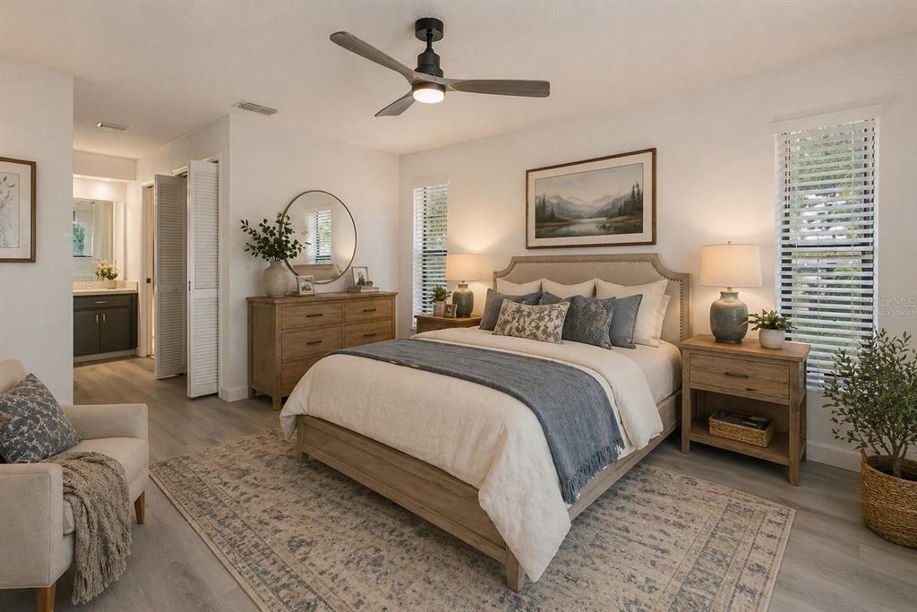 8285 Galgano Lane Spring Hill, FL 34606 - Photo 19 of 55 a bedroom with a bed and a chandelier