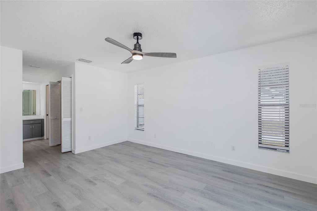 8285 Galgano Lane Spring Hill, FL 34606 - Photo 20 of 55 wooden floor in an empty room with a window