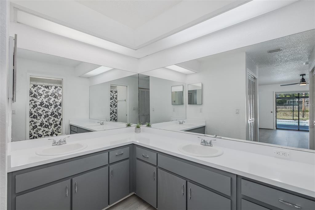 8285 Galgano Lane Spring Hill, FL 34606 - Photo 24 of 55 a bathroom with a sink and a mirror