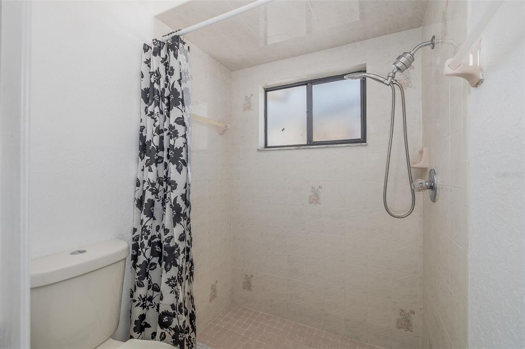 8285 Galgano Lane Spring Hill, FL 34606 - Photo 26 of 55 a bathroom with a shower curtain and a shower