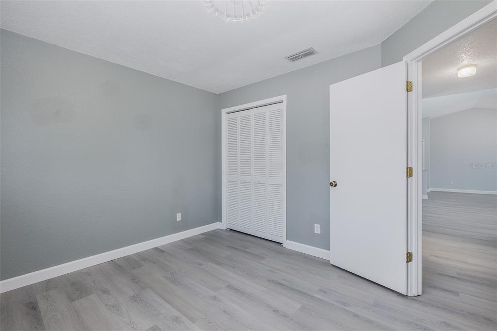 8285 Galgano Lane Spring Hill, FL 34606 - Photo 28 of 55 a view of an empty room with wooden floor