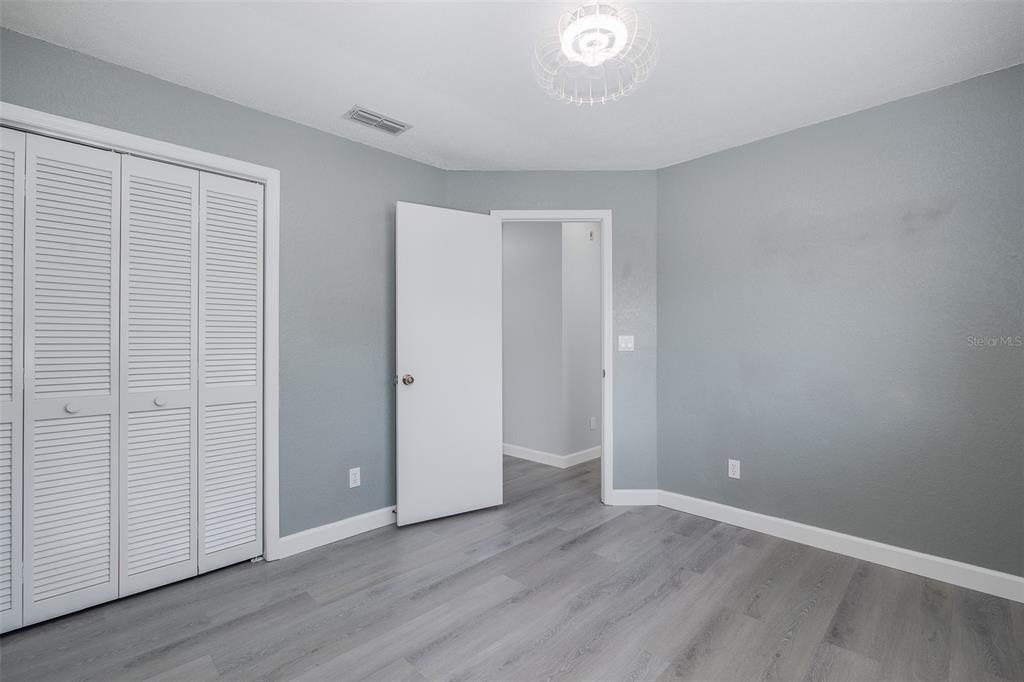 8285 Galgano Lane Spring Hill, FL 34606 - Photo 29 of 55 an empty room with wooden floor