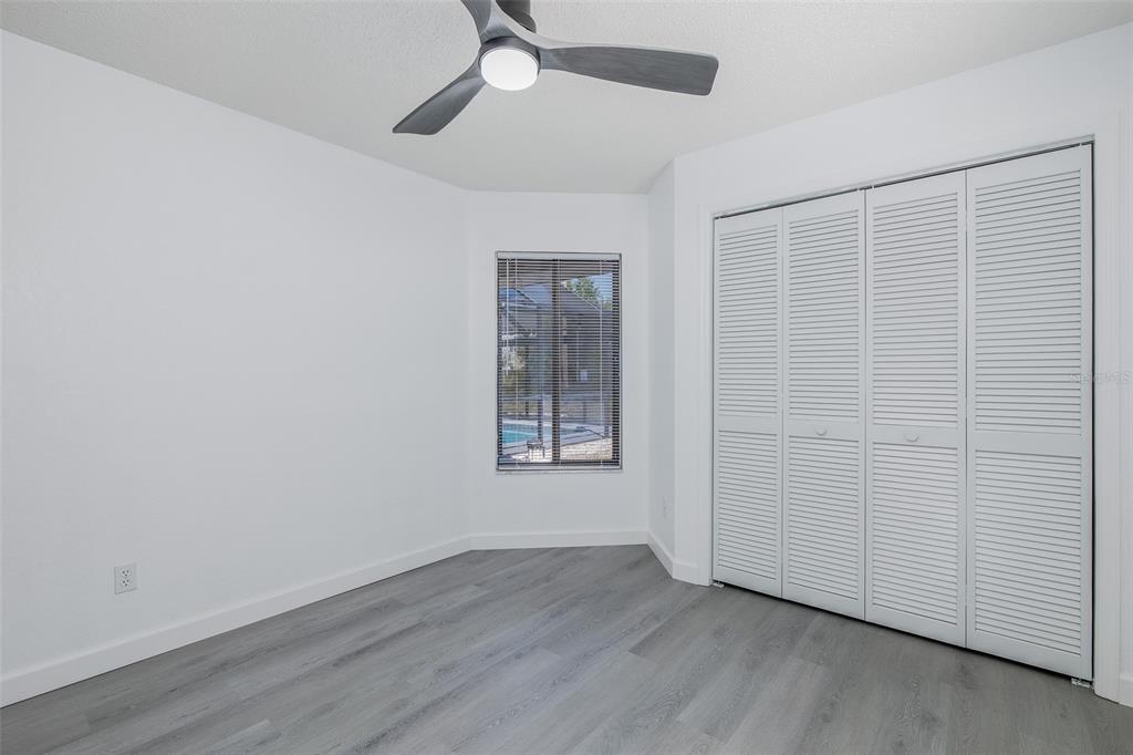 8285 Galgano Lane Spring Hill, FL 34606 - Photo 31 of 55 an empty room with wooden floor closet and windows