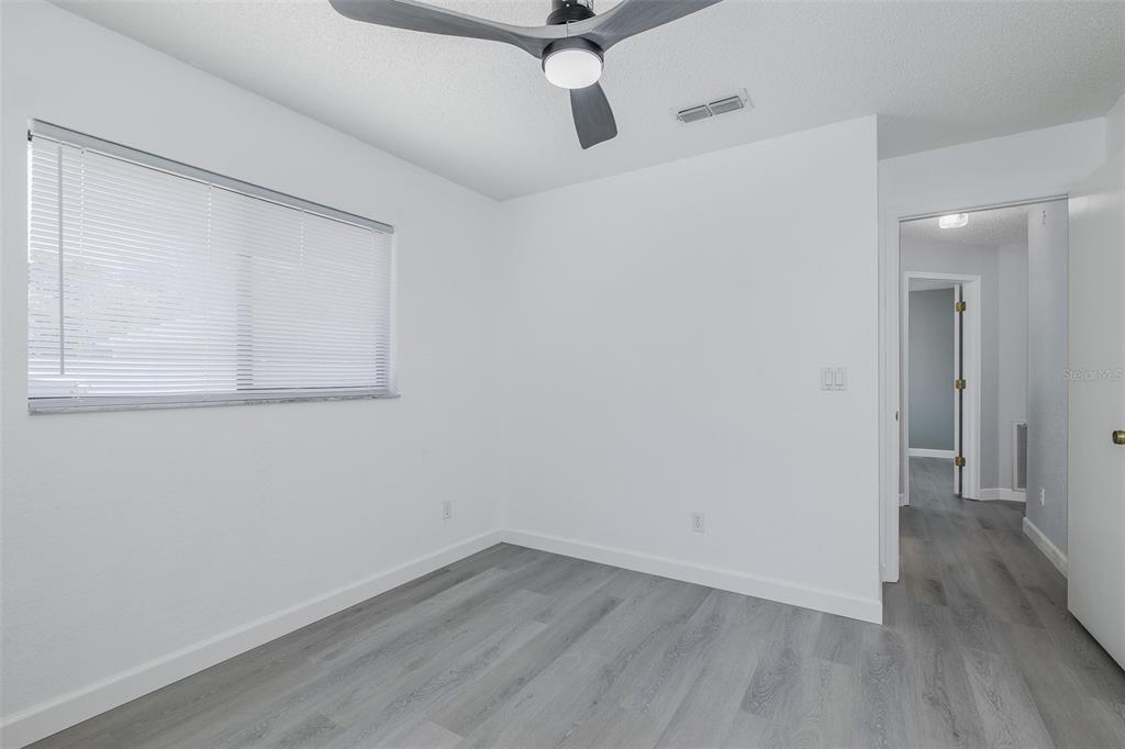 8285 Galgano Lane Spring Hill, FL 34606 - Photo 32 of 55 a view of an empty room with wooden floor
