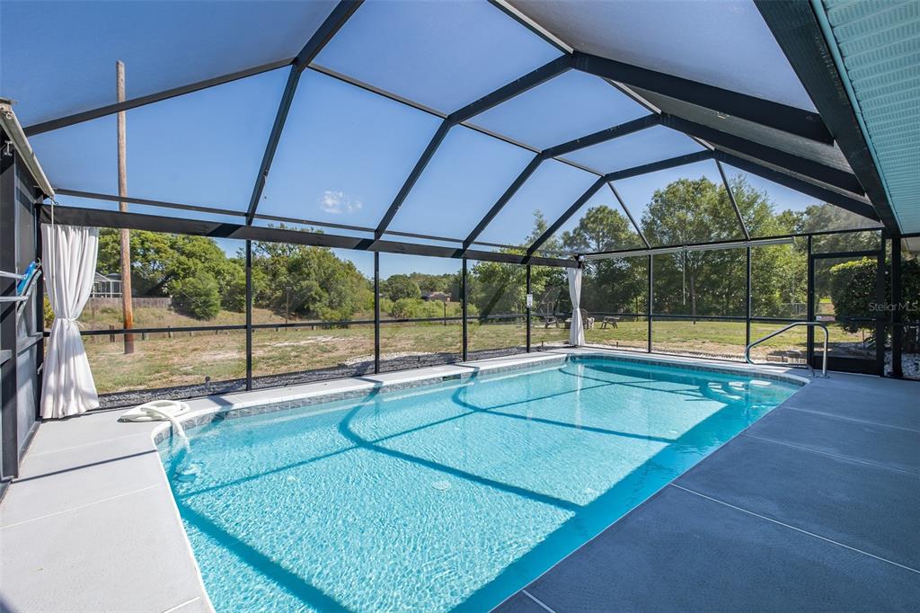 8285 Galgano Lane Spring Hill, FL 34606 - Photo 39 of 55 a swimming pool with glass door
