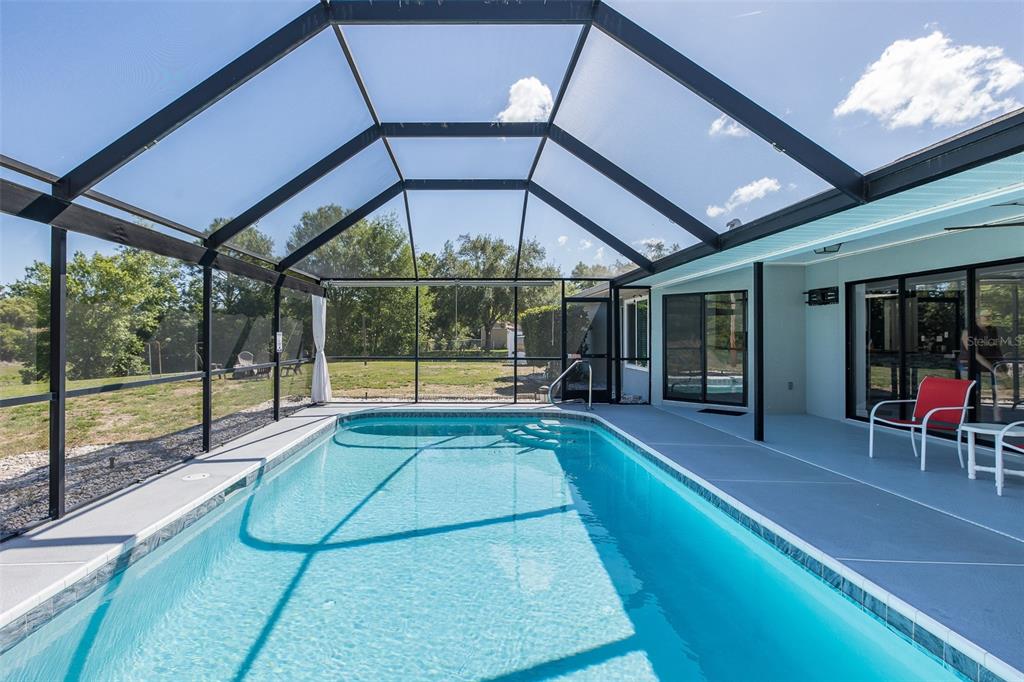 8285 Galgano Lane Spring Hill, FL 34606 - Photo 40 of 55 a view of a hall with floor to ceiling windows with an umbrella