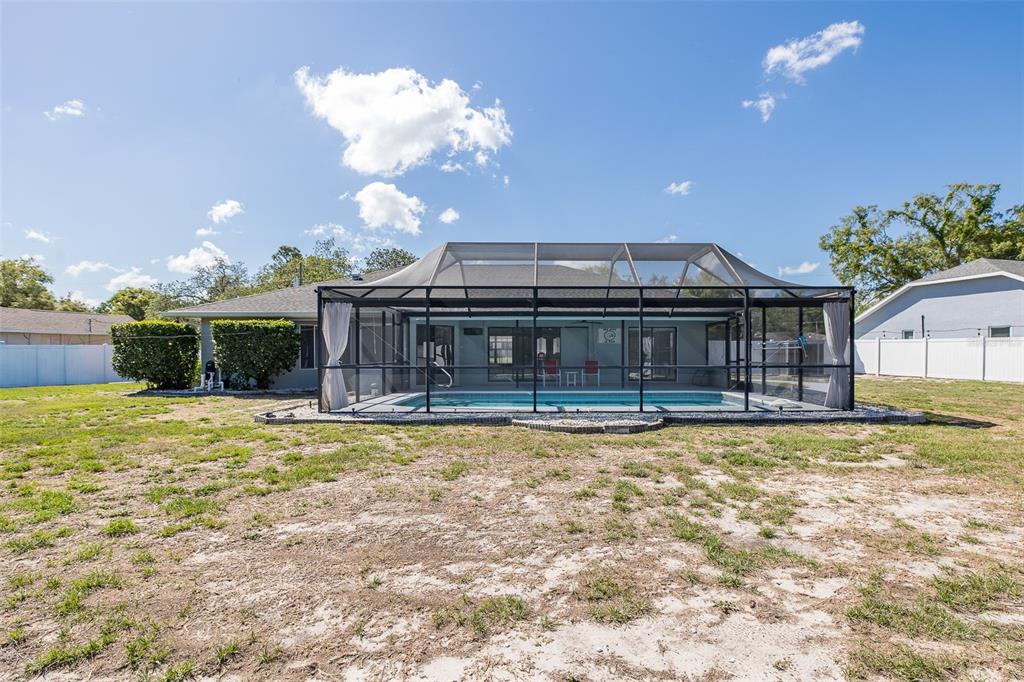 8285 Galgano Lane Spring Hill, FL 34606 - Photo 50 of 55 a view of a house with backyard and sitting area