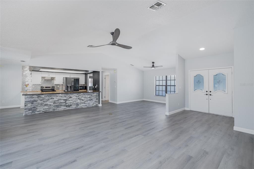8285 Galgano Lane Spring Hill, FL 34606 - Photo 7 of 55 a view of empty room with wooden floor
