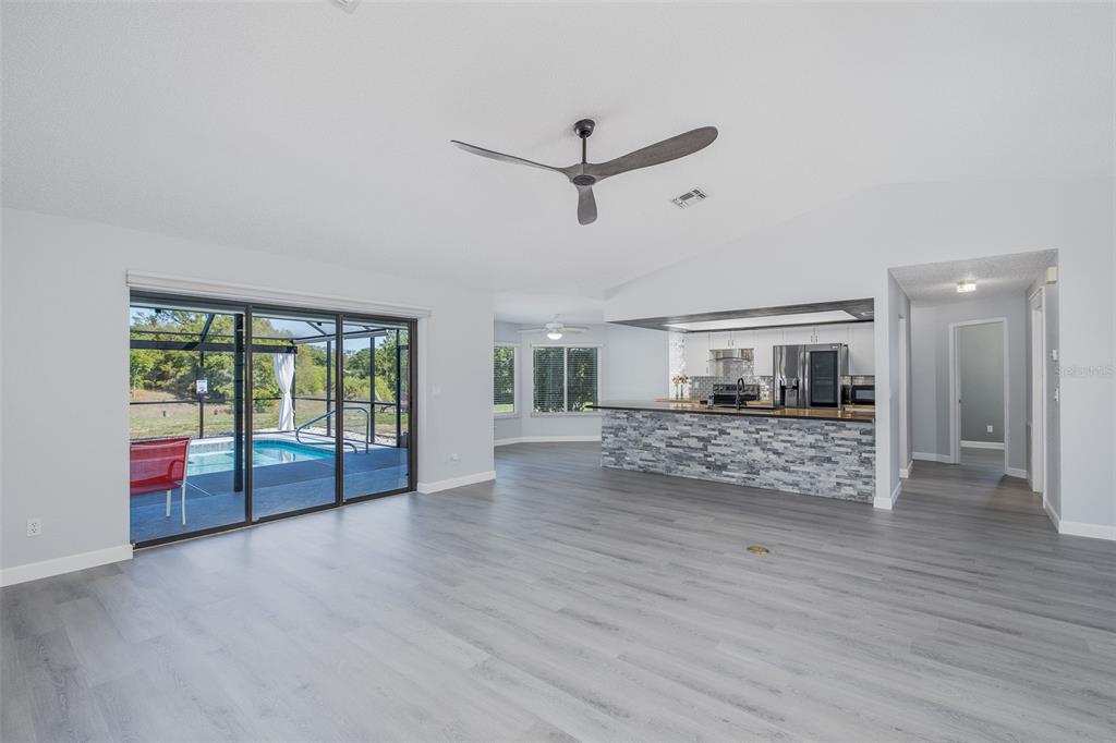 8285 Galgano Lane Spring Hill, FL 34606 - Photo 8 of 55 a view of empty room with wooden floor and fan