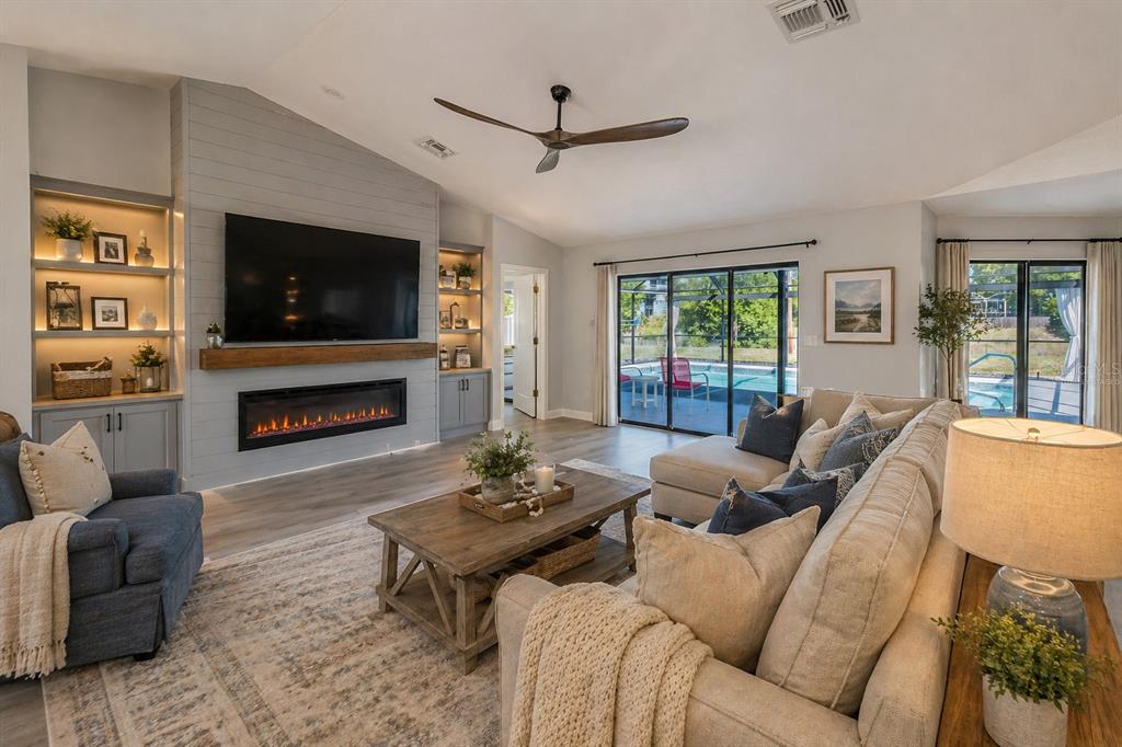 8285 Galgano Lane Spring Hill, FL 34606 - Photo 10 of 55 a living room with furniture a flat screen tv and a fireplace