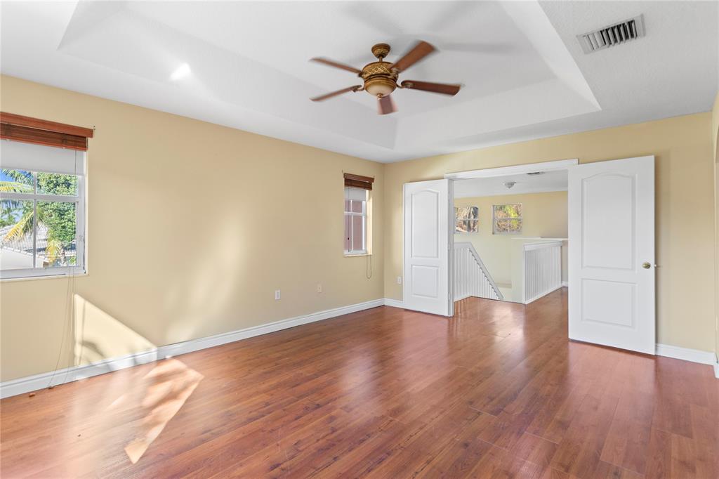 2704 Southwest 128th Avenue Miramar, FL 33027 - Photo 20 of 54 a view of an empty room with window and wooden floor