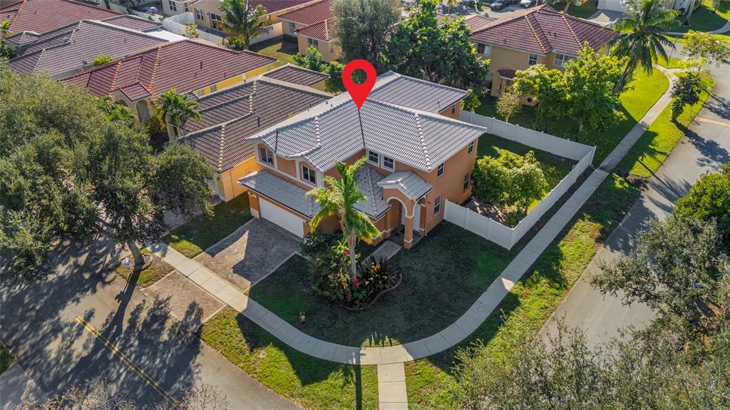 2704 Southwest 128th Avenue Miramar, FL 33027 - Photo 2 of 54 an aerial view of a house with a yard and a garden