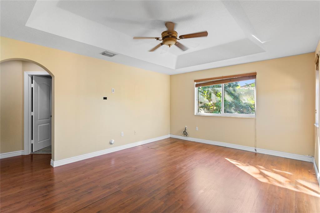 2704 Southwest 128th Avenue Miramar, FL 33027 - Photo 21 of 54 a view of an empty room with wooden floor and a window
