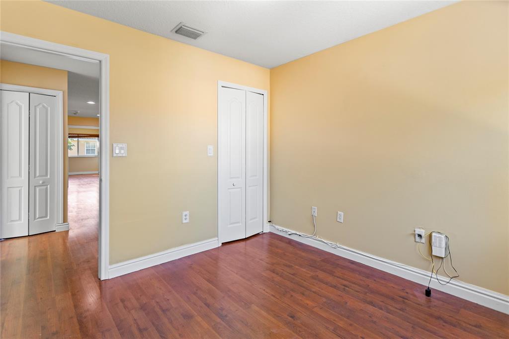 2704 Southwest 128th Avenue Miramar, FL 33027 - Photo 35 of 54 a view of an empty room with wooden floor