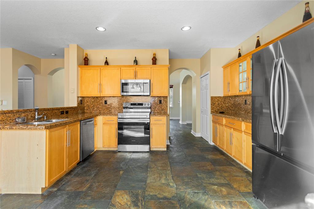 2704 Southwest 128th Avenue Miramar, FL 33027 - Photo 37 of 54 a kitchen with stainless steel appliances a refrigerator and a stove