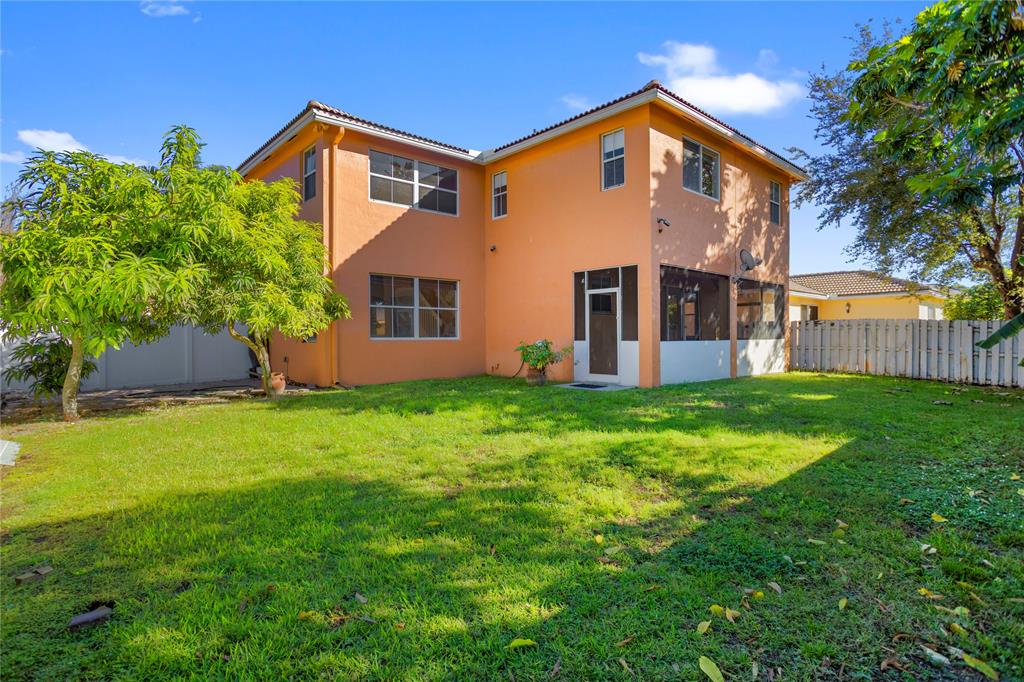 2704 Southwest 128th Avenue Miramar, FL 33027 - Photo 43 of 54 a front view of house with yard and green space