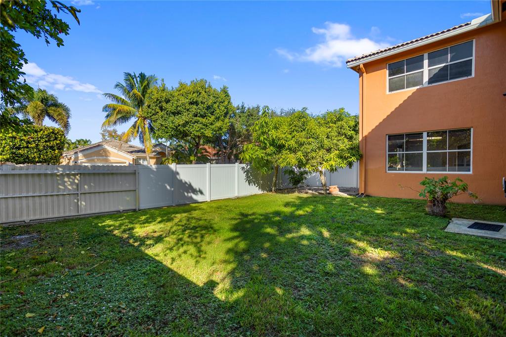 2704 Southwest 128th Avenue Miramar, FL 33027 - Photo 47 of 54 a backyard of a house with plants and outdoor seating