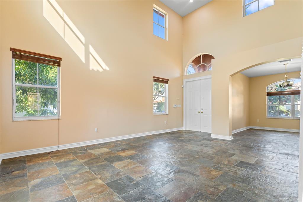 2704 Southwest 128th Avenue Miramar, FL 33027 - Photo 7 of 54 a view of an empty room with window and chandelier fan