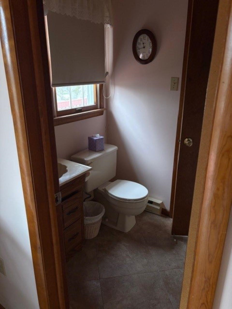 216 2nd Cape May, NJ 08204 - Photo 6 of 16 a white toilet sitting next to a wooden vanity and a window