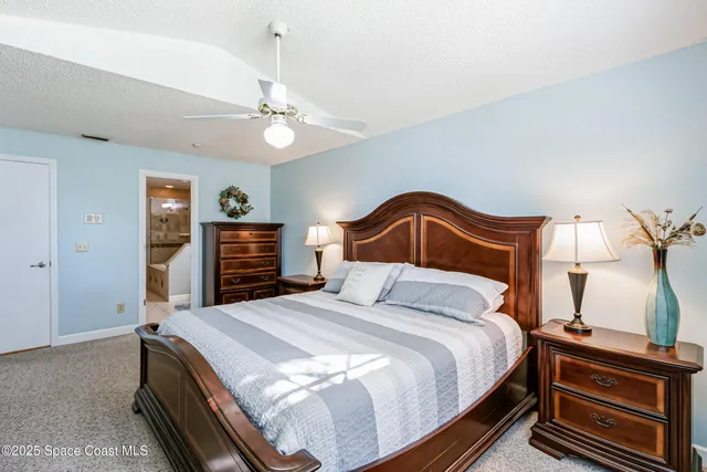 a bedroom with a bed and a dresser with a bookshelf
