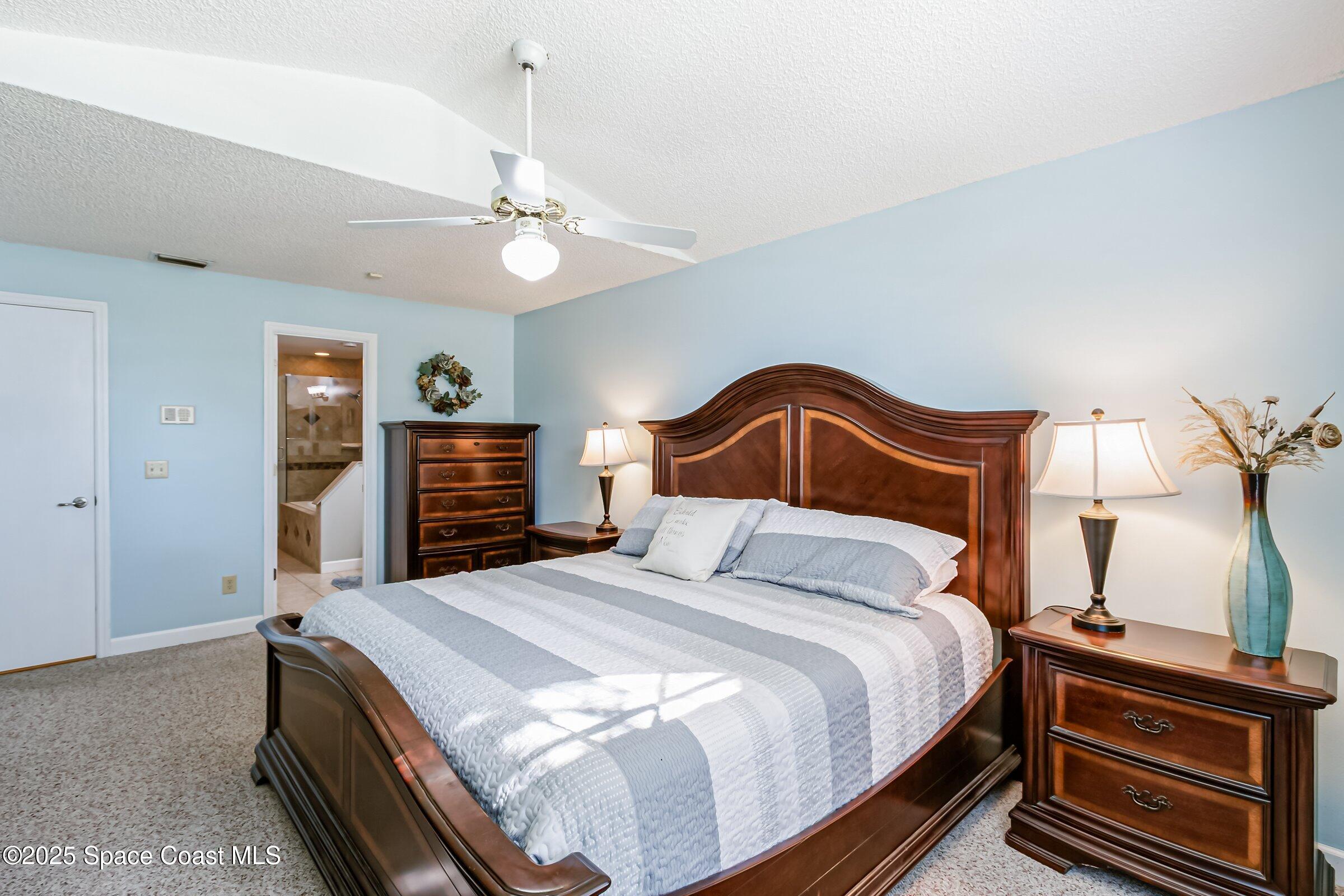 4351 Silver Lake Drive Melbourne, FL 32901 - Photo 11 of 55 a bedroom with a bed and a dresser with a bookshelf