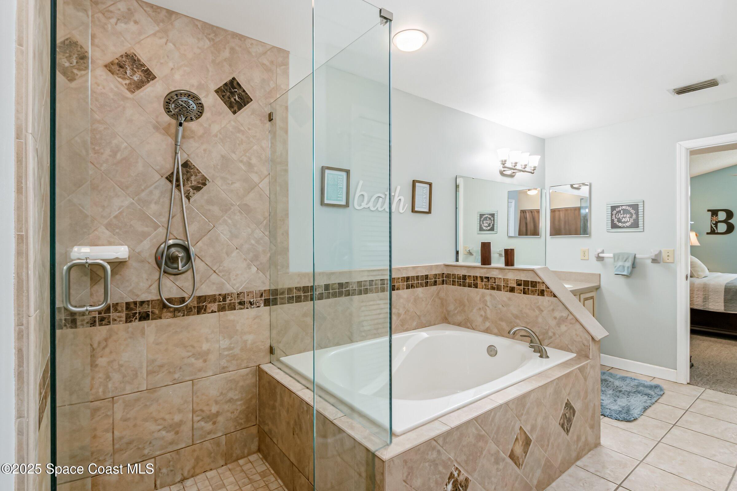 4351 Silver Lake Drive Melbourne, FL 32901 - Photo 13 of 55 a bathroom with a bath tub and shower