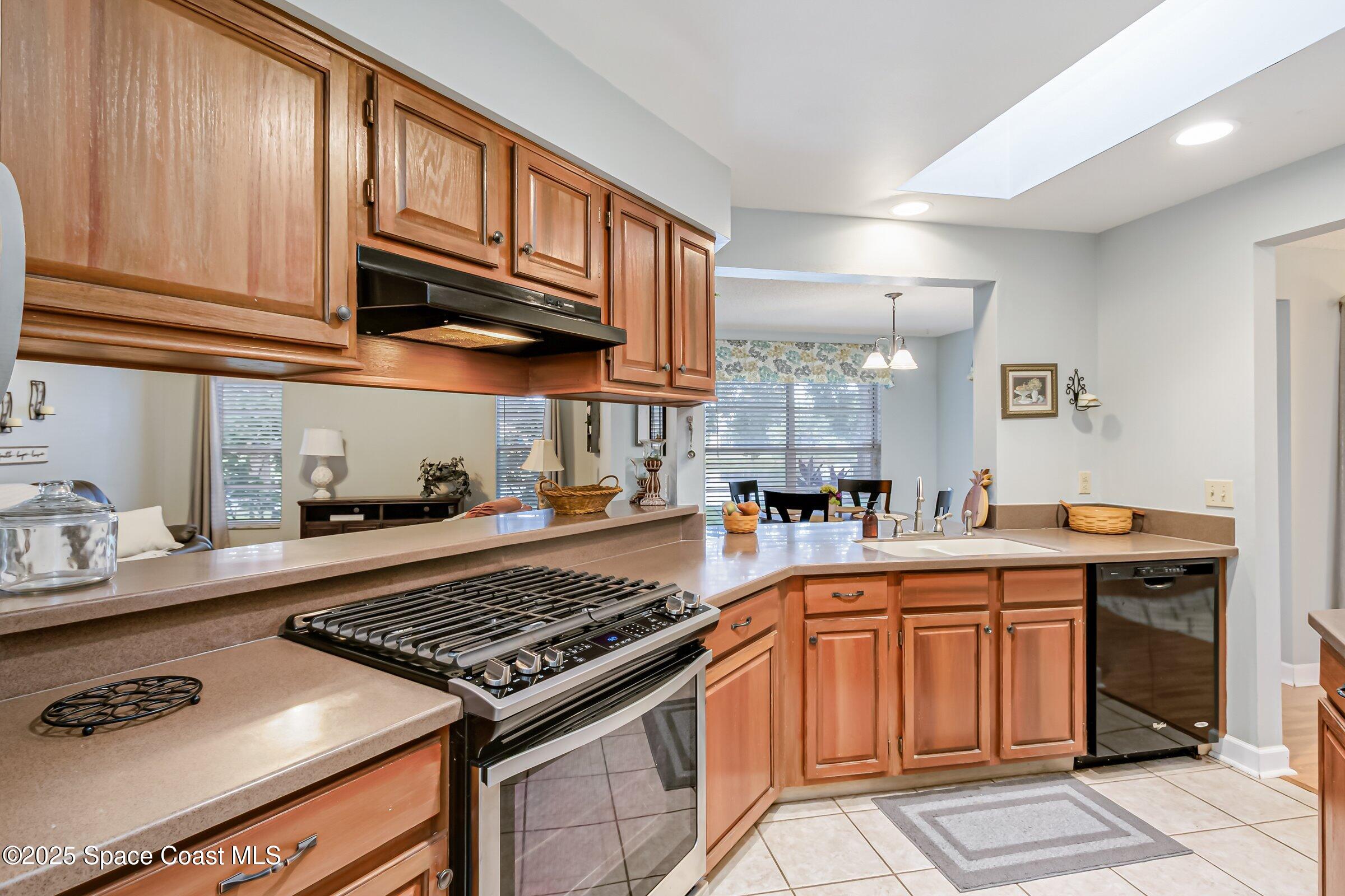 4351 Silver Lake Drive Melbourne, FL 32901 - Photo 16 of 55 a kitchen with a stove and a sink